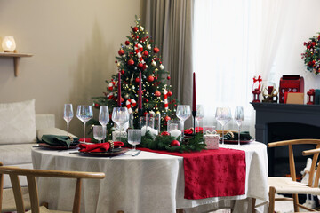 Festive table setting with Christmas decor indoors
