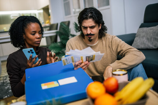 Young couple reviewing bills together