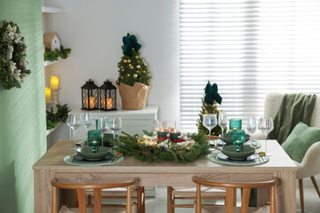 Festive table setting with Christmas decor indoors