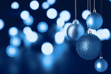 Christmas balls and bokeh lights on dark background. Happy winter holidays