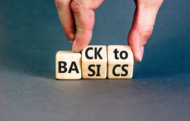 Back to basics symbol. Concept words Back to basics on wooden block. Beautiful grey table grey background. Businessman hand. Business back to basics concept. Copy space.