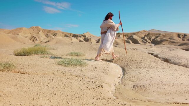 A Solitary Traveler walking through vast desert landscape. Christian and spiritual concept