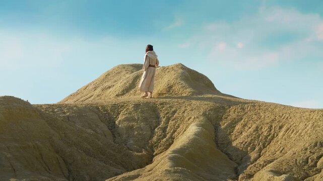 The solitary figure of the Christ ascending through vast desert landscape. Christian and spiritual concept