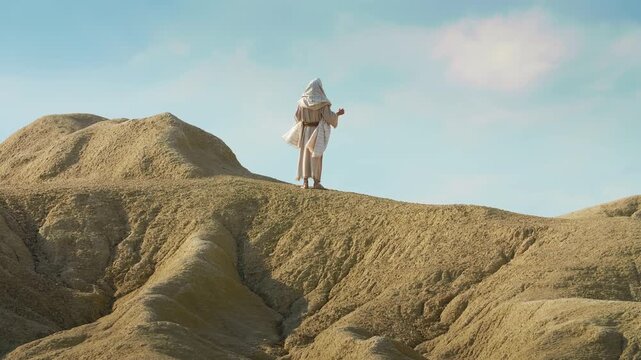 A solitary figure of Christ praying on a hilltop from Wilderness of Judea. Christian and spiritual concept