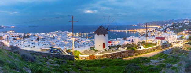 Evening panoramic view of Mykonos, Greece with windmill, harbor, and white houses