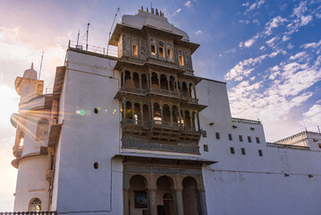 Monsoon Palace also known as Sajjan Garh Palace structure bathed in golden sunlight, featuring beautifully carved balconies and intricate jharokhas located in Aravalli hill range, Uaipur, Rajasthan.