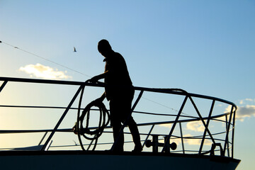 Fishermen throwing rope to moor the fishing boat in the port of Santa Pola town © SoniaBonet