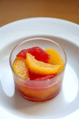 Fresh fruit in a glass on a white plate