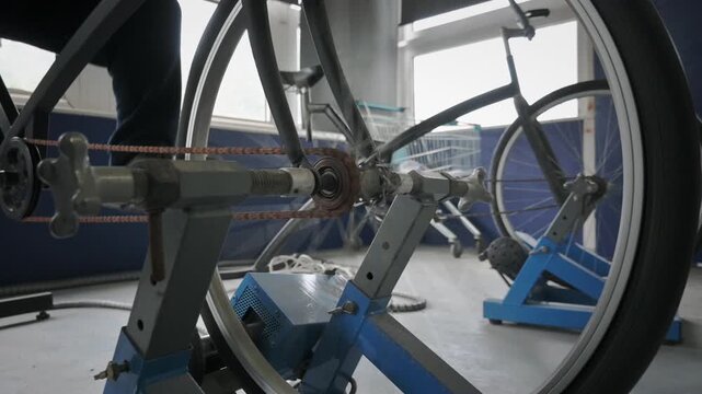 The Rapidly Rotating Bicycle Chain, Gear and Energy Converter Components Are Clearly Visible.