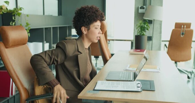 Businesswoman deep in thought while managing files and documents