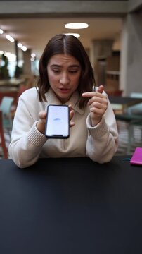 Vertical screen angry young woman raises her voice at her phone after an ai chat reply goes wrong showing frustration tension and the emotional moment of reacting to incorrect answers