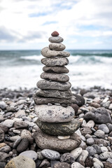 Stone figures on a beach with a beautiful sky in Tenerife. Canarian Island. Balance and serenity. High quality photo.