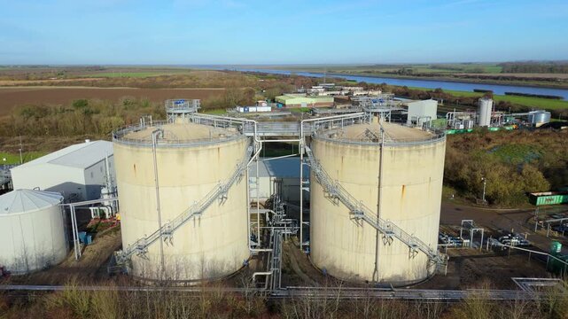 Industrial aerial drone scene of Anglian Water biosolids complex with sanitation infrastructure, sewage processing, tanks and ponds around Kings Lynn UK