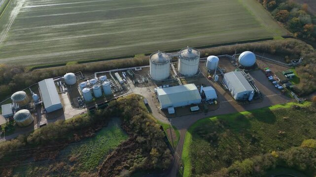 Industrial aerial drone scene of Anglian Water biosolids complex with sanitation infrastructure, sewage processing, tanks and ponds around Kings Lynn UK