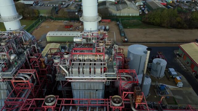 Close up Aerial drone view of Industrial power plant infrastructure, mechanical piping and vents of chimney stack and powerhouse, Sutton Bridge, UK.