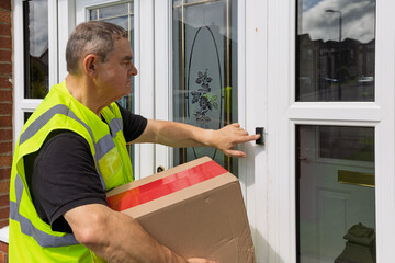 Courier holding online shopping parcel presses house doorbell for delivery