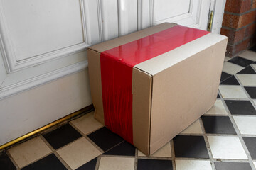 Delivered Cardboard Online Shopping Parcel Left on Doorstep of Suburban Home