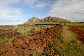 Rano Raraku volcano and ancient stone wall on Easter Island sky