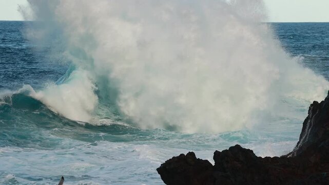Majestic rocky coastline with rugged cliffs and vibrant turquoise waves crashing against the shore, showcasing the beauty of nature and coastal landscapes