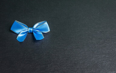 blu bow on black background