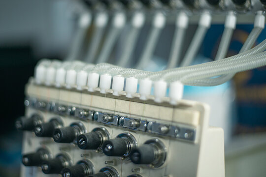 Industrial Sewing Machine With Thread Spools Close Photo. High quality photo