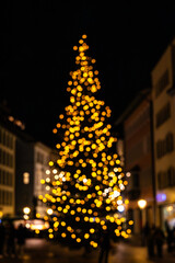 Christmas Tree shape with lights - intentionally out of focus as festival background