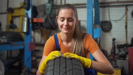 A diligent female mechanic with a warm smile inspects a car tire, demonstrating her commitment and expertise in automotive service at a well-equipped garage - Powered by Adobe