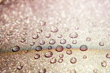 Close-up of water drops on a shimmering surface. 