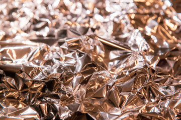 Background. Crumpled metallic foil with light reflection.