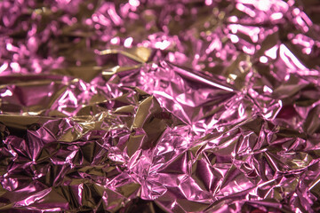 Background. Crumpled metallic foil with light reflection.