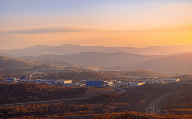 Industrial Landscape at Sunset Amidst Rolling Hills and Endless Horizons