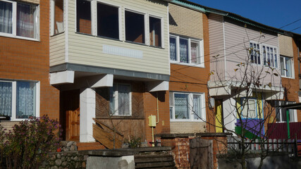Row of houses with balconies in a neighborhood on a clear sunny day