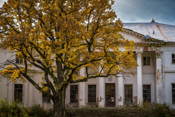 Abandoned classical manor house in autumn