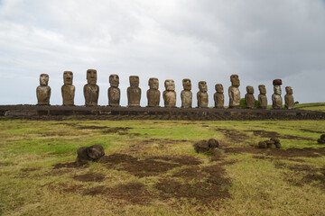 Ancient moai statues under cloudy sky on Easter Island, Chile