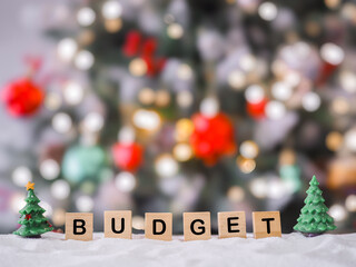 Wooden blocks with the word BUDGET with shiny light for Christmas background. The concept about budget planning and allocation in year 2026
