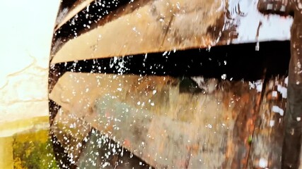 Close-up view of an old hydraulic engine operating outdoors