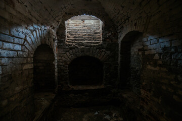 Dark and creepy vaulted brick cellar