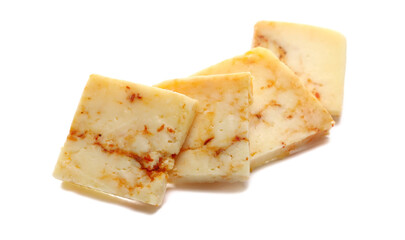 Slice cheese with red crushed paprika isolated on white background