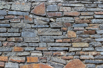 Laying a wall of granite tiles.