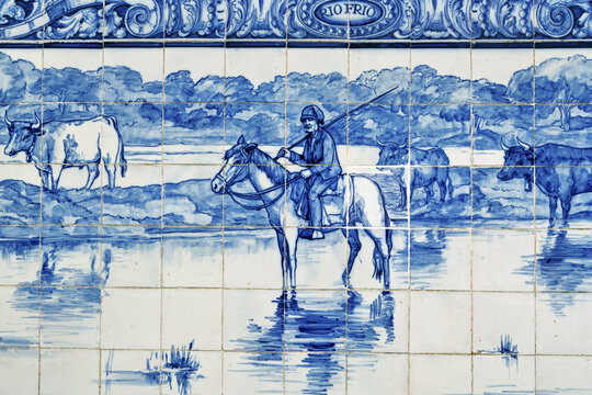 azulejos panel in Pinhal Novo station, Portugal, showing a pastoral scene in blue and white tones. The artwork features several horses standing in shallow water, with trees and landscape