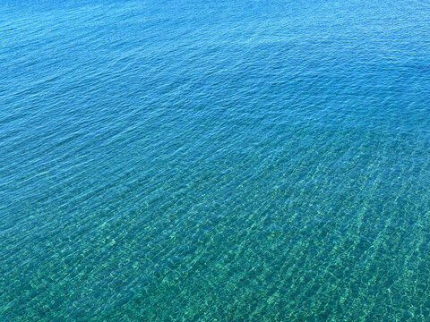 Blue sea water calm surface aerial view.