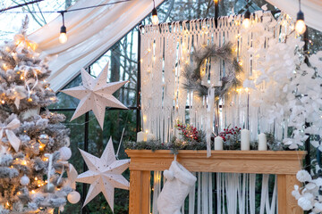 Cozy Christmas greenhouse interior decorated with white Christmas tree and modern stars