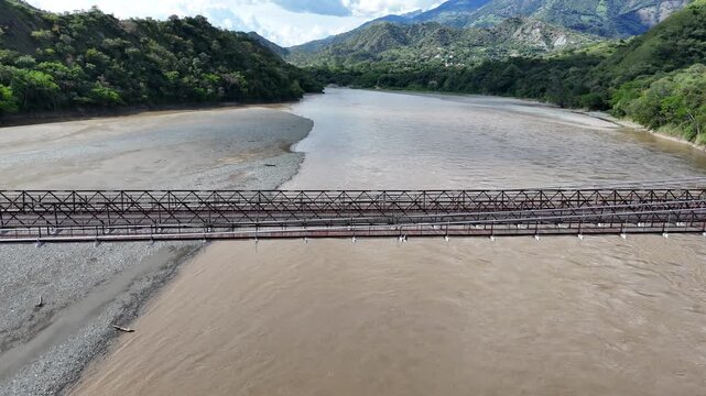DIY Destinations host Charles Huang on the Puente de Occidente bridge over the Cauca River near Santa Fe de Antioquia, Colombia. An engineering marvel and national monument.