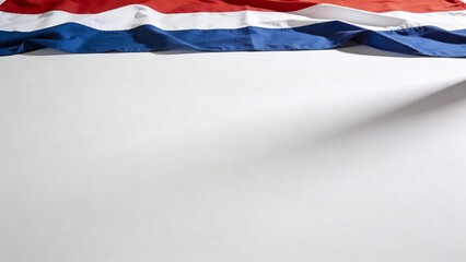 A close-up of a red, white, and blue flag draped over a smooth surface, ideal for patriotic designs and layouts.