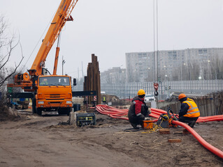 Workers are installing water supply pipeline system with plastic pipes