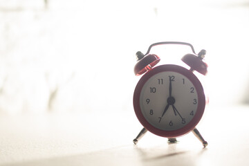 Retro alarm clock with seven o'clock. Old style filtered photo