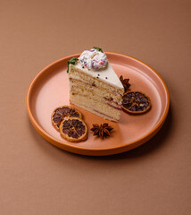 A slice of sweet layered cake with a Christmas ornament and fruit flavor. A slice of cake