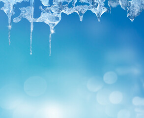 Icicles Hanging from a Roof Against a Clear Blue Sky