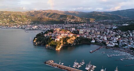 Aerial view of Agropoli's cityscape, with its historic buildings, busy harbor, and coastline meeting the Tyrrhenian Sea, Agropoli, Campania, Italy.