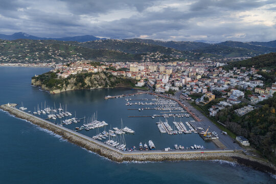 Aerial view of a yacht-filled harbor, with boats docked along a sturdy stone pier and a backdrop of the town, Agropoli, Campania, Italy.